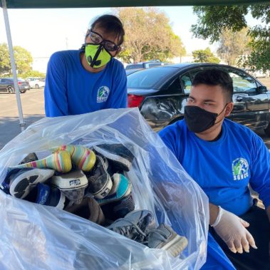 Two teens collecting shoes
