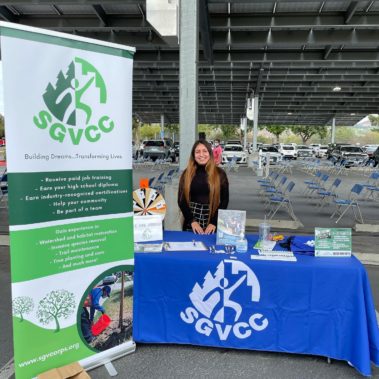 Young lady standing at booth for San Gabriel Valley Conservation Corps