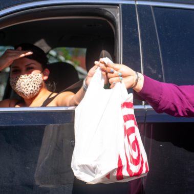 Handing food to a woman in her car