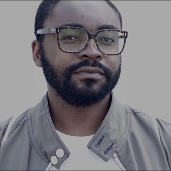 African American male smiles into the camera