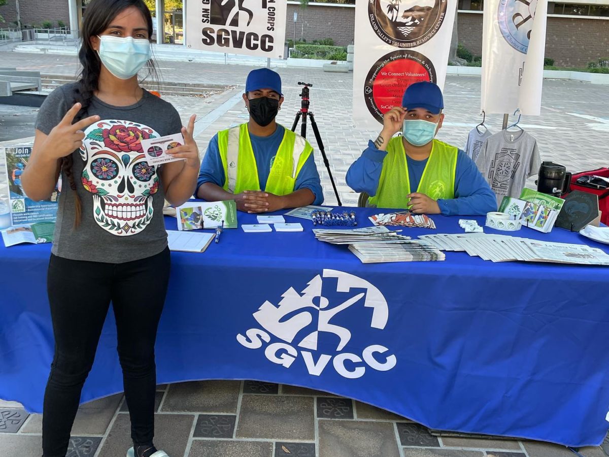 Teen girl and two teen boys working a booth at a fair
