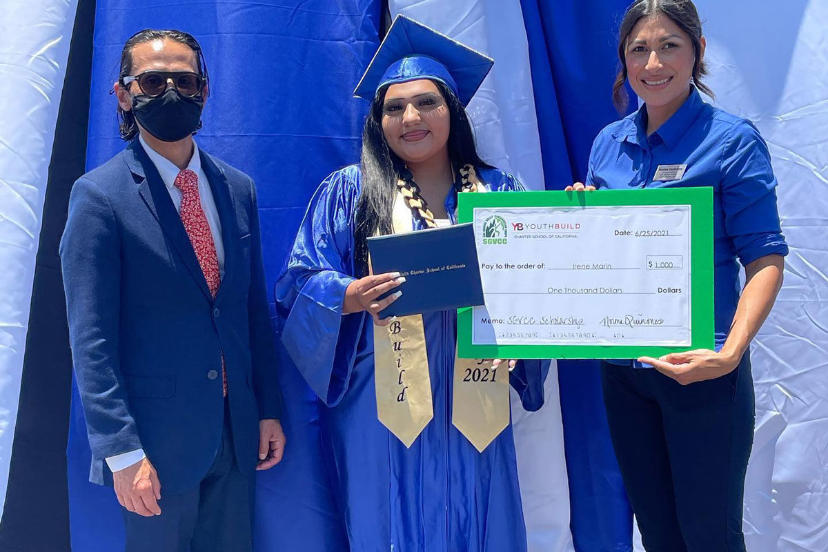Graduate hold her degree with her Dad and Norma