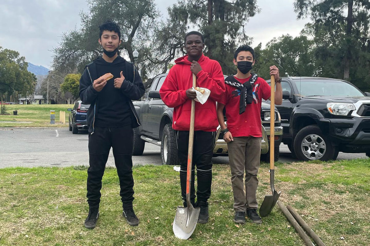 Three Teen boy and two of them are holding shovel's.
