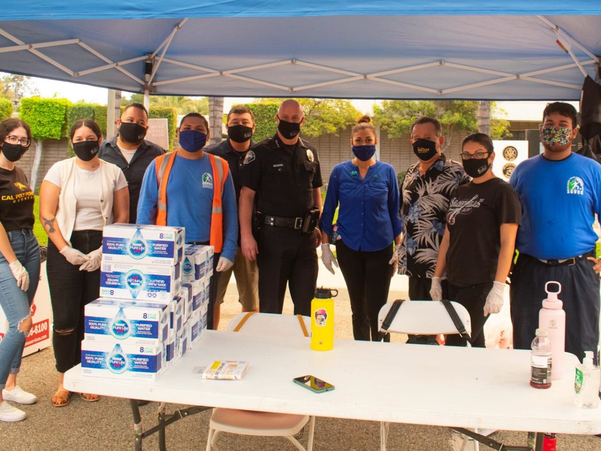 Community leaders and Corp Members at a booth working together