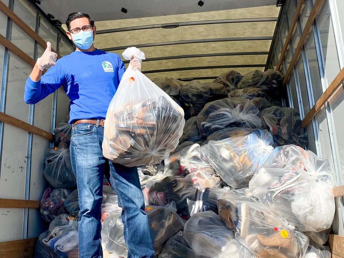 Male hold a bag of shoes with a thumbs up